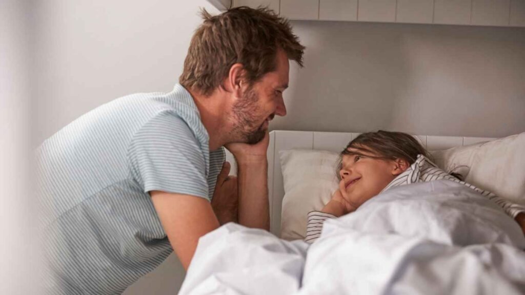 Daddy Doing Bedtime Routine Sitting Next to His Daughter