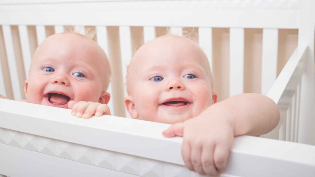 Twin Baby Looks Similar Smiling in The Crib